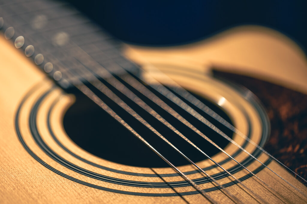 Close up of guitar and strings with shallow depth of field, soft focus. Sound hole and metal strings of professional musical instrument in focus. SSUCv3H4sIAAAAAAAACpySwW7CMAyG75P2DlXOVIKmLZRXQTu4iaERIUFJyjQh3n1O0qLsulv92f7tP+7z86Oq2AheCXasnjGiWGk9++AgKGsIbzcLd2gkupI8HO+3JQBVRihVsE6BLuEIQUwGbkjQzFpH/EpJ5gOE2aOPuyxIQMALaWT4lsgLn3JcrYmUpA5KMbYpmJ/HxFaUxf/VmT++3oYvaMRPWrgw4lAjZCOnXMqu3wHdrbQGs1S2cPWwAnQs4IUSqDs4+NN3d0oocymIDVO6y6ok7GyCi1u9zTBt7R1GHV/9TGNw5RN4T+Vy5cVsQX+BvRVzjA3J06LKJB0nhjvOO960zbDrWt7sD/1+KcgHnRTppHVWIYrFVcnSlYobsGHb7nsQfY0Asm4RzvXYHbBuDrtuGGQr2zOnW7x+AQAA//8DADUaSMu5AgAA